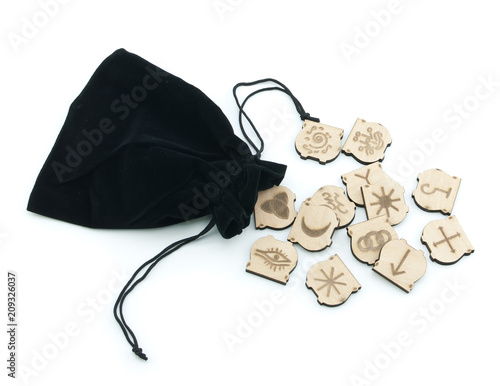 Runes and velvet bag on white background