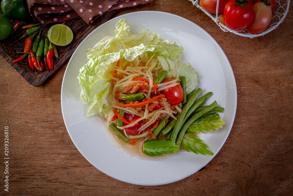 Thai papaya salad or Som Tum Isolated on the white background Thai papaya salad or Som Tum Isolated on the white background