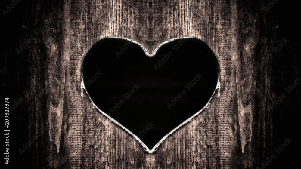 Heart carved in a tree on a dark background Heart carved in a tree on a dark background