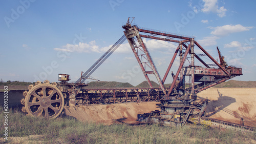 The operating machines in the quarry for the extraction of manganese ore