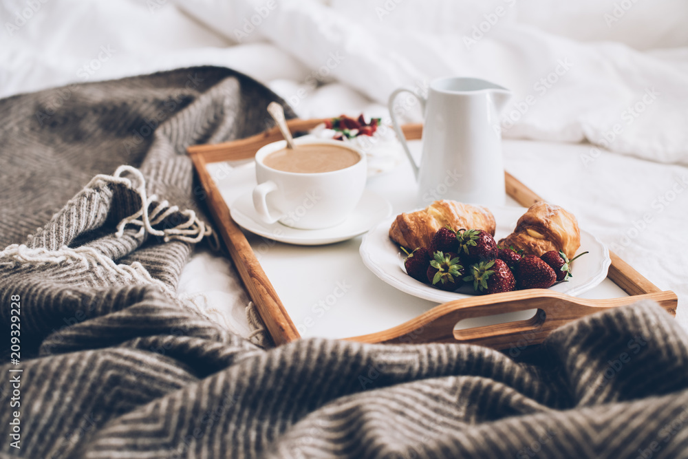 Traditional romantic breakfast in bed in white and beige bedroom - obrazy, fototapety, plakaty 