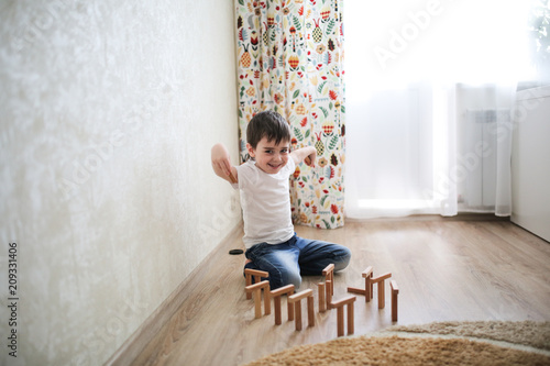 Boy Caucasian brunette happy playing onfloor photo