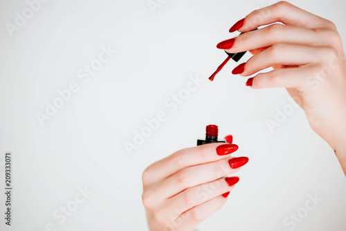 Obraz na plátně Beautiful girl showing red manicure nails