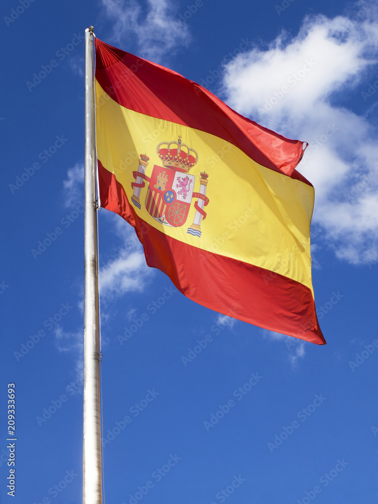 Flag of Spain, called La Rojigualda, waving on a blue sky. Flag of Spain, called La Rojigualda, waving on a blue sky.