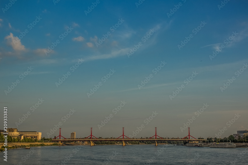 urban city scape with river and bridge in evening time