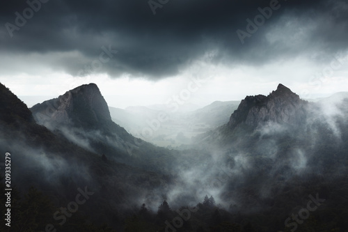 Fototapeta Dramatic weather on Sanadoire and Tuilière rocks in Auvergne province - France