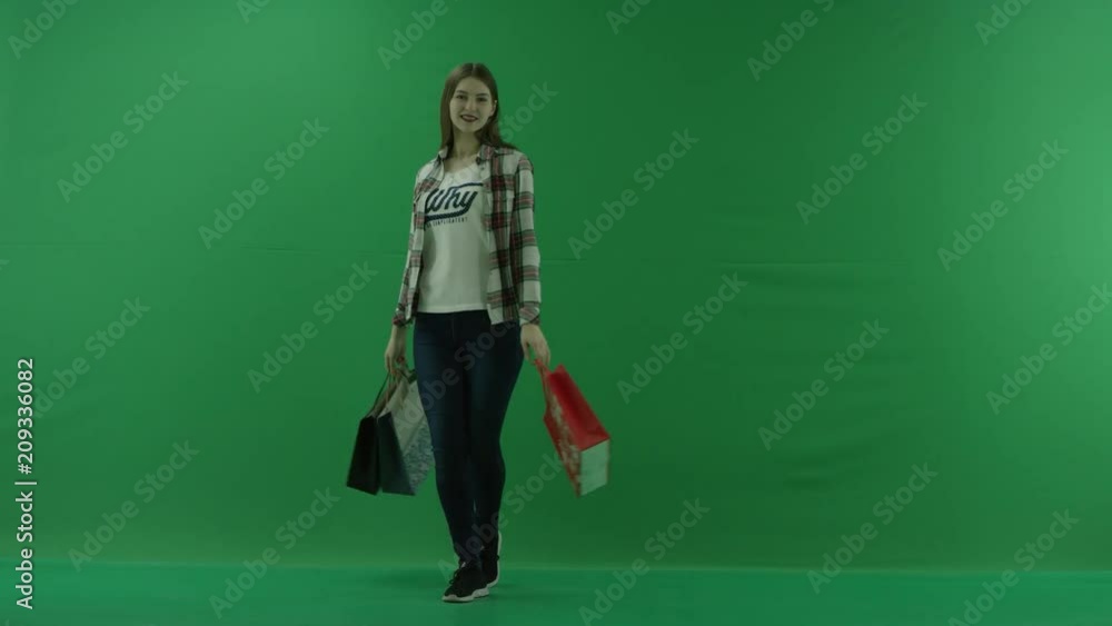 girl with bags comes out on the right side and spinning on green screen girl with bags comes out on the right side and spinning on green screen