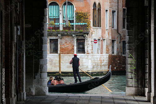 Canals of Venice with gondola and gondolier 