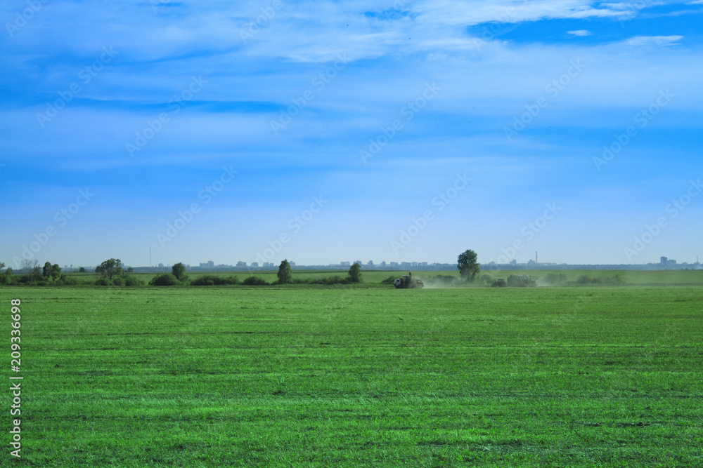 harvesters on green field in summer