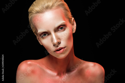 attractive woman posing for fashion shoot, isolated on black