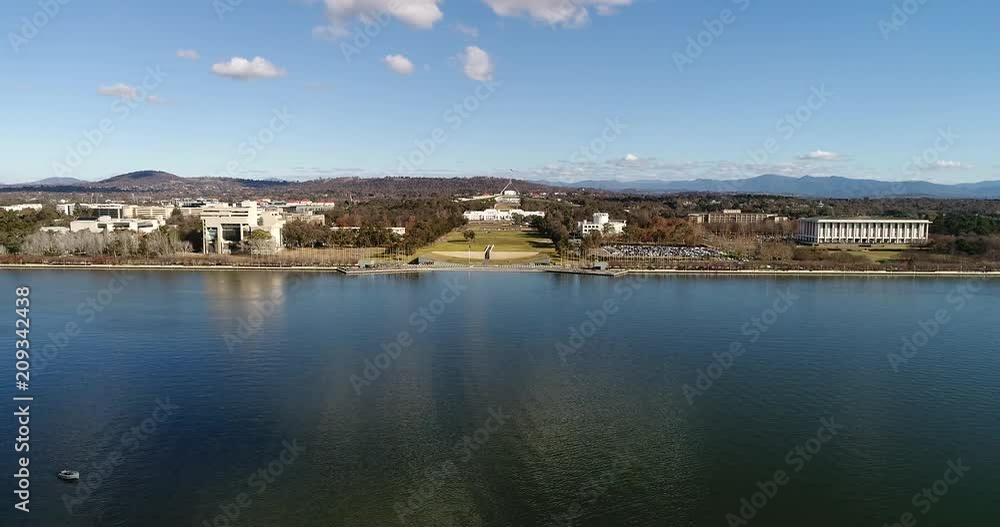 Wide Burley Griffin lake in Canberra along waterfront of government district and capitol hill with government buildings and institutions on a sunny day.
Wide Burley Griffin lake in Canberra along waterfront of government district and capitol hill with government buildings and institutions on a sunny day.