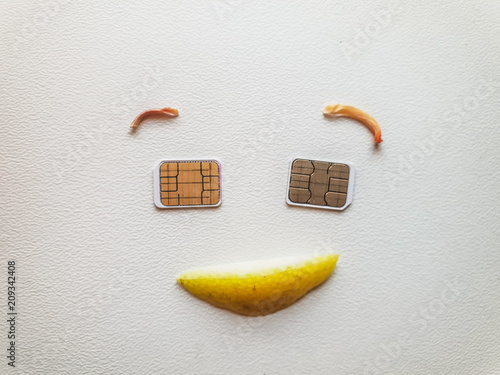 two micro sim cards lying in the shape of a smiling face photo