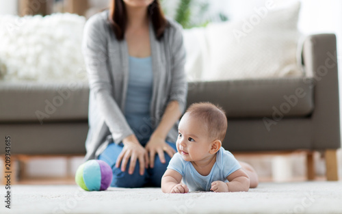 babyhood, childhood and people concept - sweet little asian baby boy and mother at home