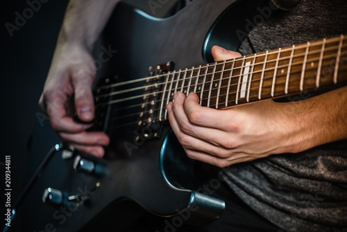 Male hands playing electric guitar