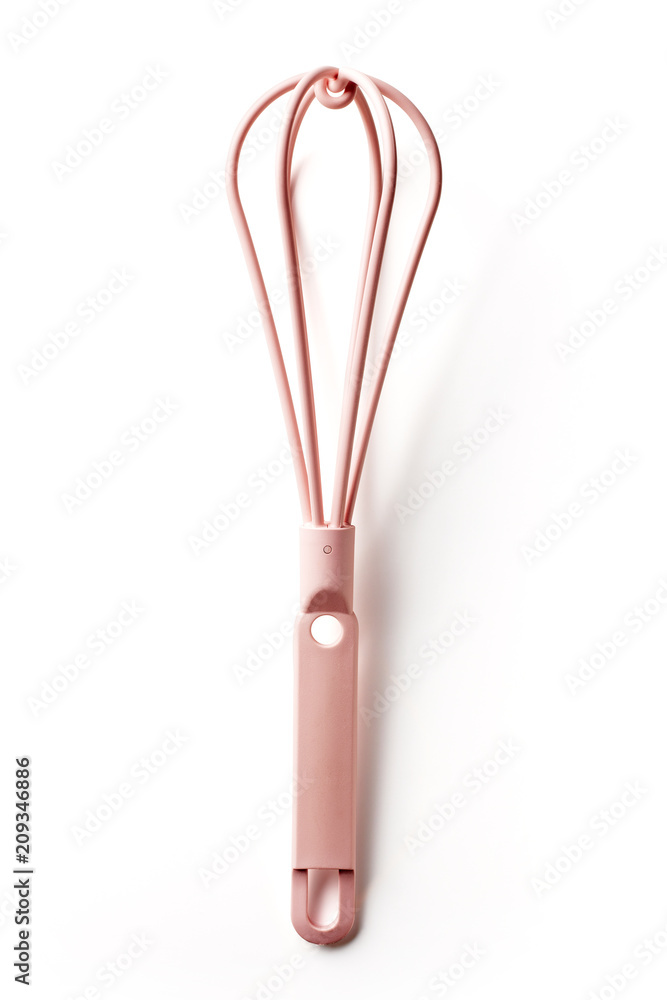Fototapeta premium Pink kitchen whisk isolated on white, from above