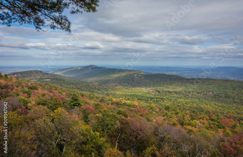 Overlooking the Shawangunk Mountain Range surrounded by bright fall foliage on a partly cloudy afternoon at Minnewaska State Park, Kerhonksen, NY