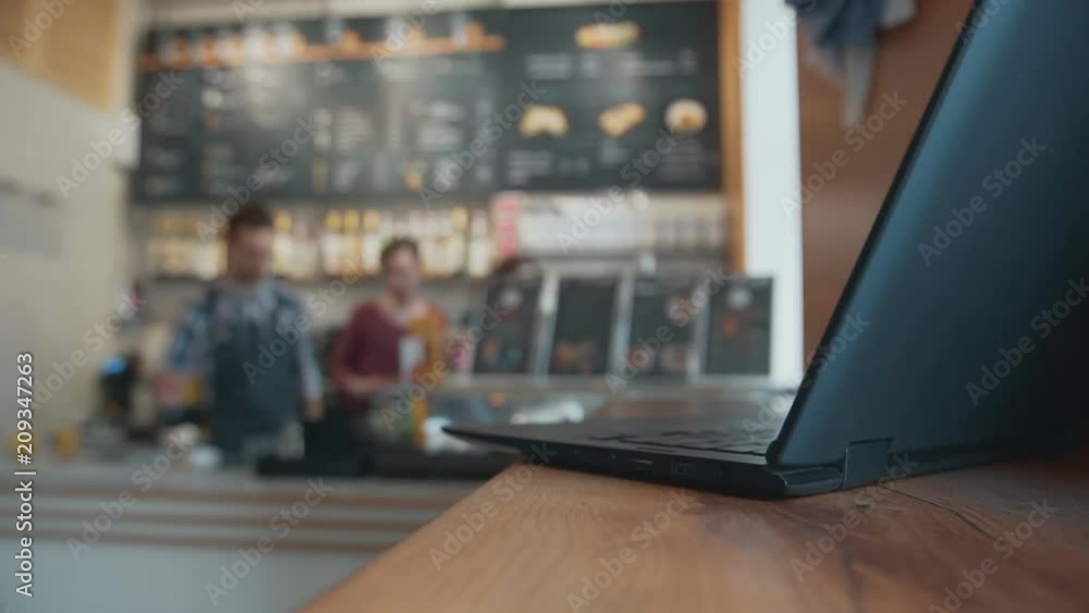 Laptop on table with blur background of share workspace coffee cafe. Laptop on table with blur background of share workspace coffee cafe.