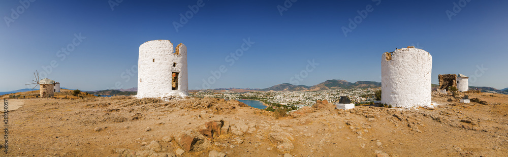 Sunny view of oldfashioned windmills at the hill of Bodrum, Mugla province, Turkey. Sunny view of oldfashioned windmills at the hill of Bodrum, Mugla province, Turkey.