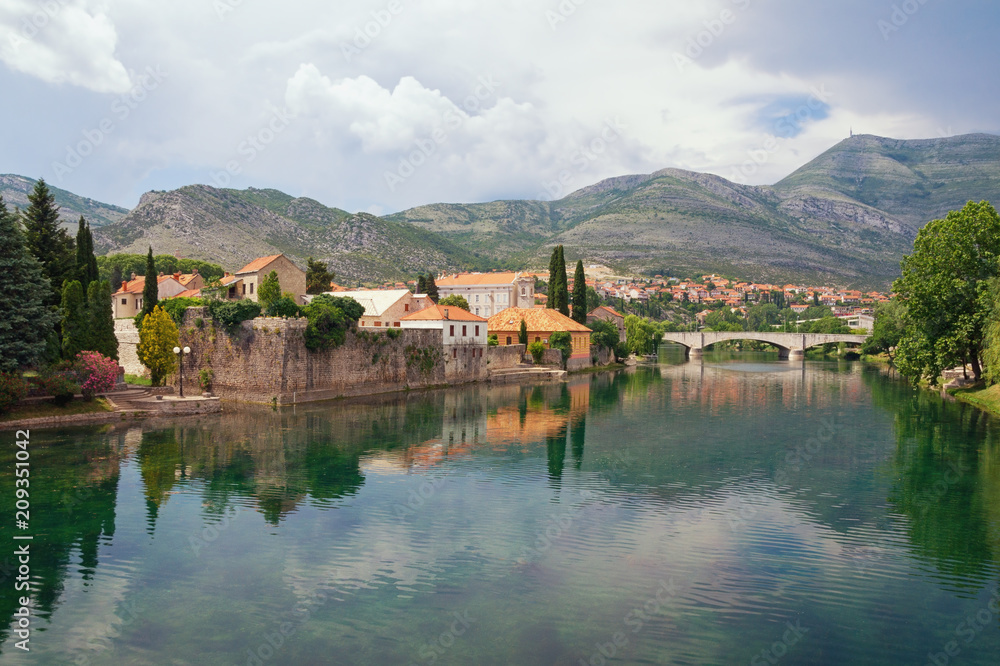 Picturesque landscape with mountains and  ancient city on the banks of the river.  Bosnia and Herzegovina, view of Trebisnjica river  and Old Town of Trebinje