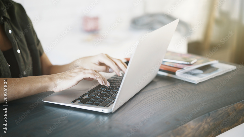 Close up of white woman hands on black keyboard of a laptop at home Close up of white woman hands on black keyboard of a laptop at home