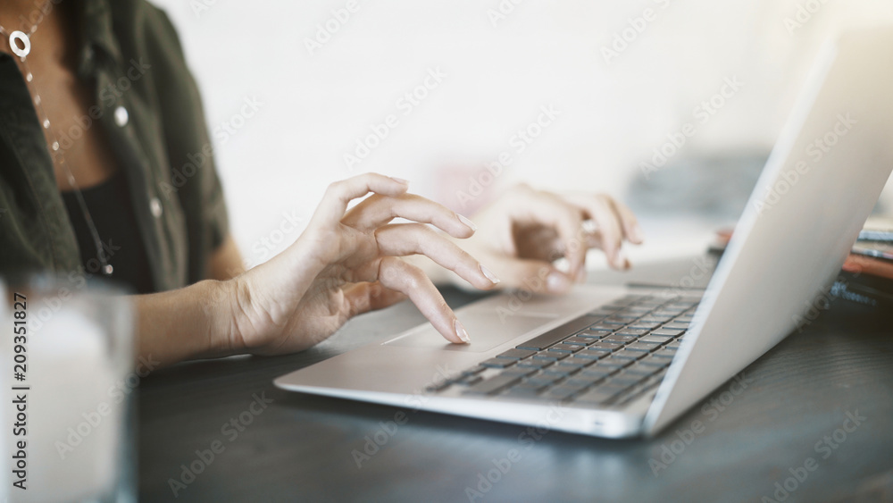 Close up of white woman hands on black keyboard of a laptop at home Close up of white woman hands on black keyboard of a laptop at home