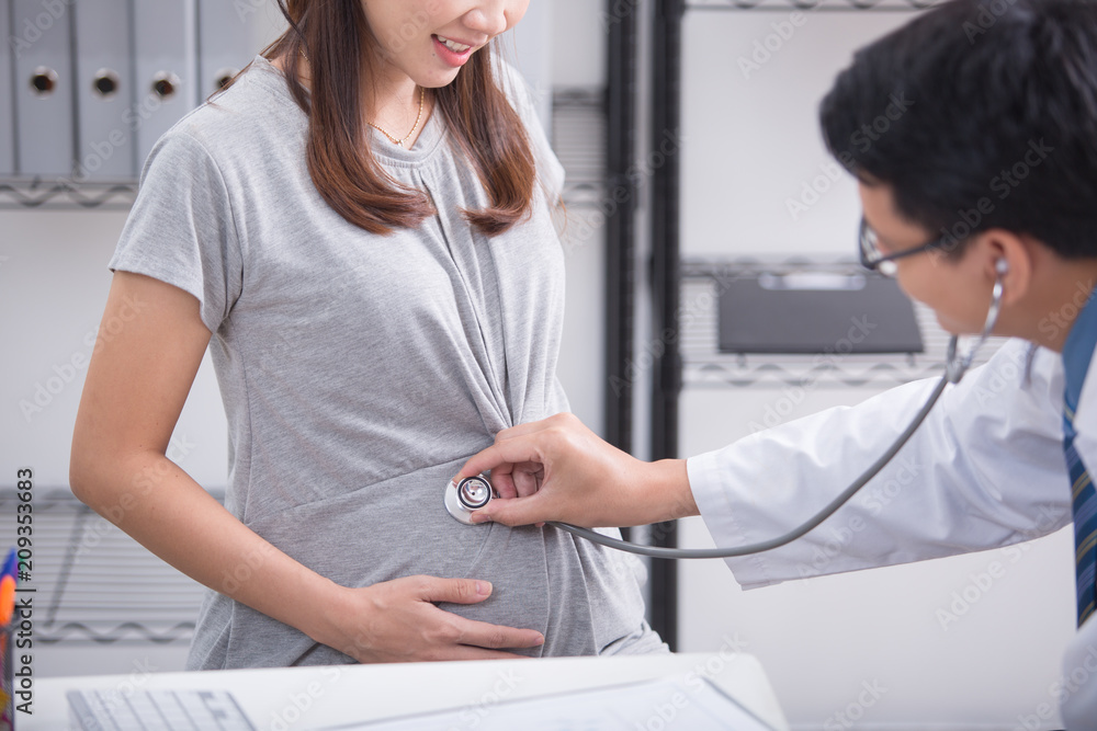 Young preganant woman expecting a baby doctor visit