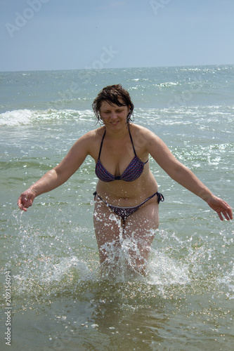 a woman plays water in the sea