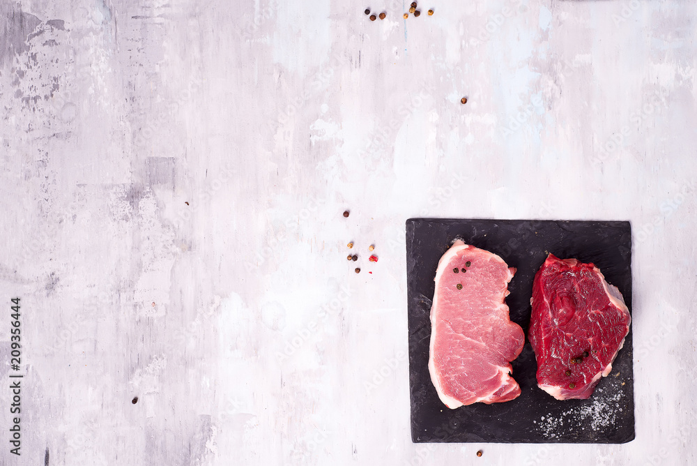 Different types of meat on dark slate cutting board. Lean proteins.