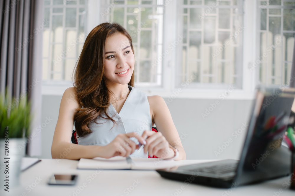 Beautiful young Asia woman working in office Beautiful young Asia woman working in office