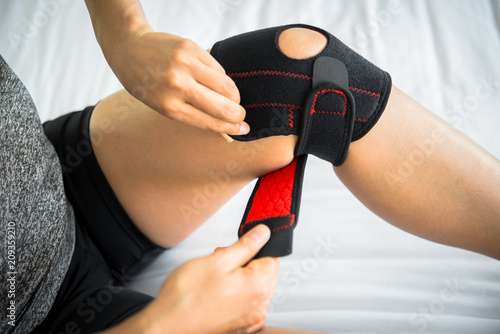 Women use knee supporter to prevent injuries.