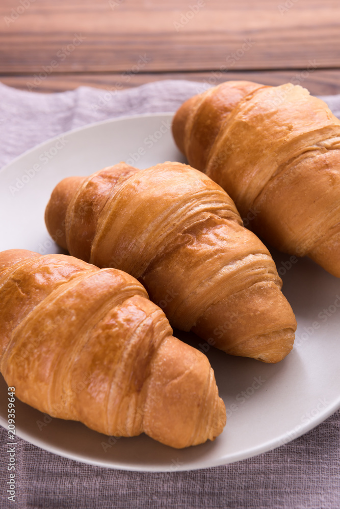 Freshly baked butter croissant. Closeup Freshly baked butter croissant. Closeup