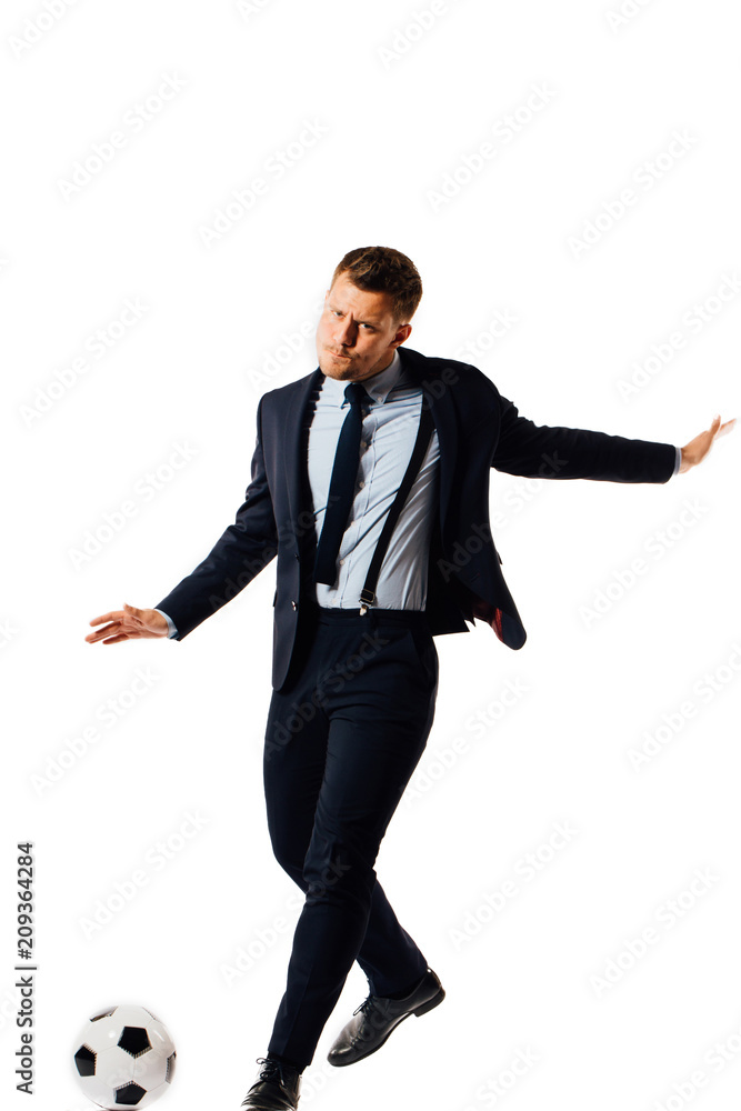 young handsome businessman manager kicking a soccer ball on white background isolated. young handsome businessman manager kicking a soccer ball on white background isolated.