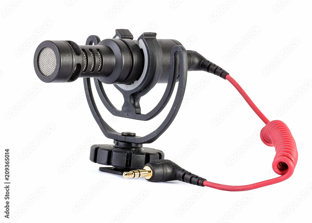 An external directional microphone for a digital camera, with gold-plated connector, on a white background, nobody An external directional microphone for a digital camera, with gold-plated connector, on a white background, nobody