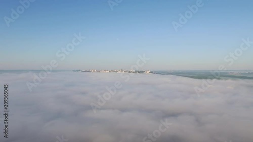 Wallpaper Mural Aerial footage on city in dense fog at summer sunny day. Foggy city landscape Torontodigital.ca