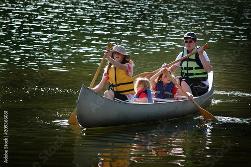 Family Canoeing Together On Lake in Wilderness