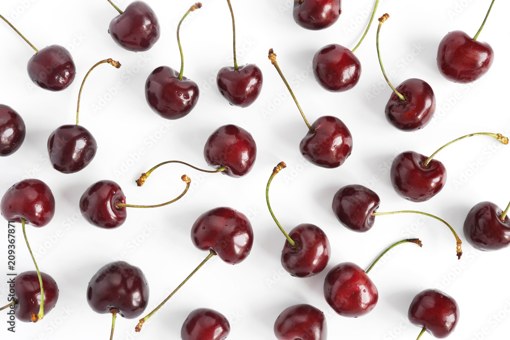 Pattern of fresh cherry isolated on a white background. top view, flat layout. Food background. Pattern of fresh cherry isolated on a white background. top view, flat layout. Food background.