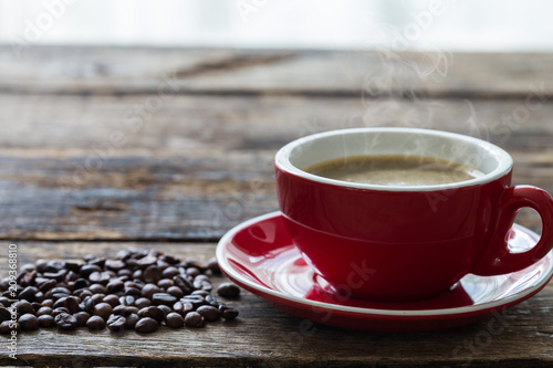 Red Coffee Cup and coffee bean on wooden background