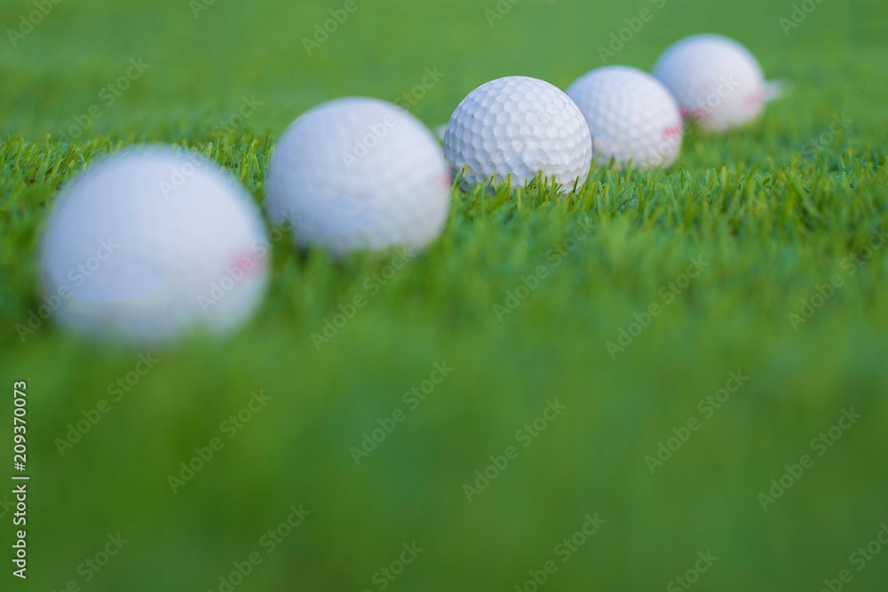Naklejka premium Five golf ball on grass.