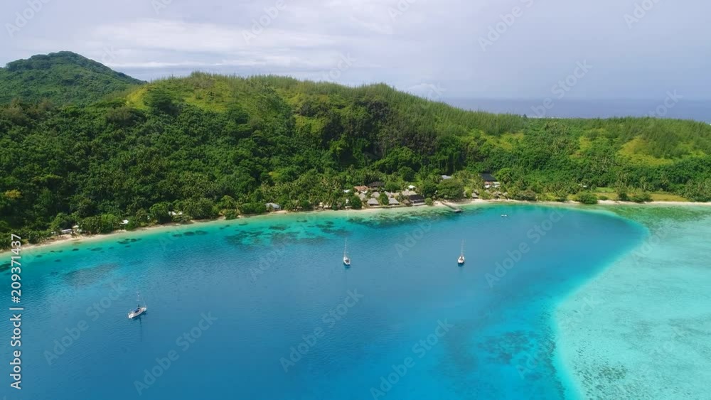 Aerial panoramic view of tropical paradise of Huahine island, turquoise clear water of blue lagoon, lush green rain forest, white sand beaches - Pacific Ocean, landscape panorama of French Polynesia Aerial panoramic view of tropical paradise of Huahine island, turquoise clear water of blue lagoon, lush green rain forest, white sand beaches - Pacific Ocean, landscape panorama of French Polynesia