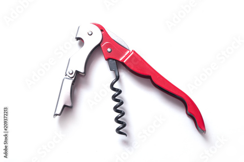 closeup of red metallic corkscrew on white background photo