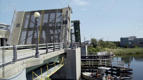 Boat Passes Through the Quogue Canal Draw Bridge photo