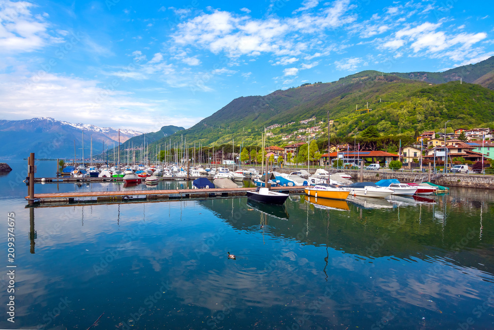 Port of Gera Lario with moored boats in sunny summer day. Lombardia, Italy