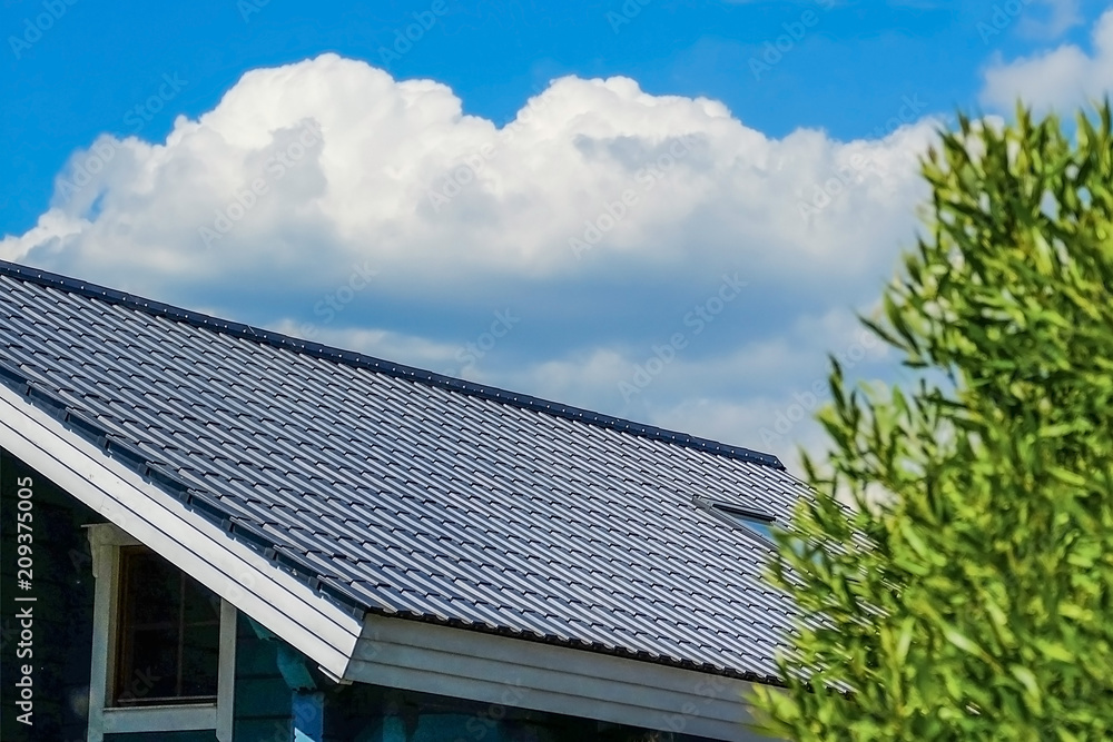 Fototapeta premium Tile is a building materials used for the roof of the house. Against the sky.