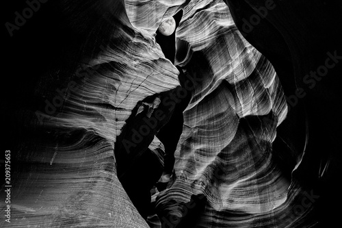 Slot Canyon near Page, Arizona; Rich, black and white photograph with moon peaking through the top of a slot canyon. Suitable for the travel industry, business offices, and hotel lobbies.