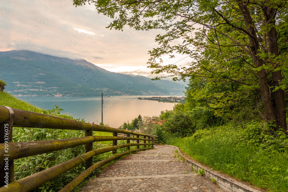 Obraz premium a view of the most beautiful lake in Italy, Lago di Como. Photo taken from a hill near San Rocco church at sunset