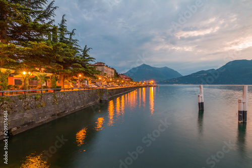 holidays in Italy - a view of a city Bellano, with the most beautiful lake in Italy - Lago di Como in background. Area of famous Belano City at sunset