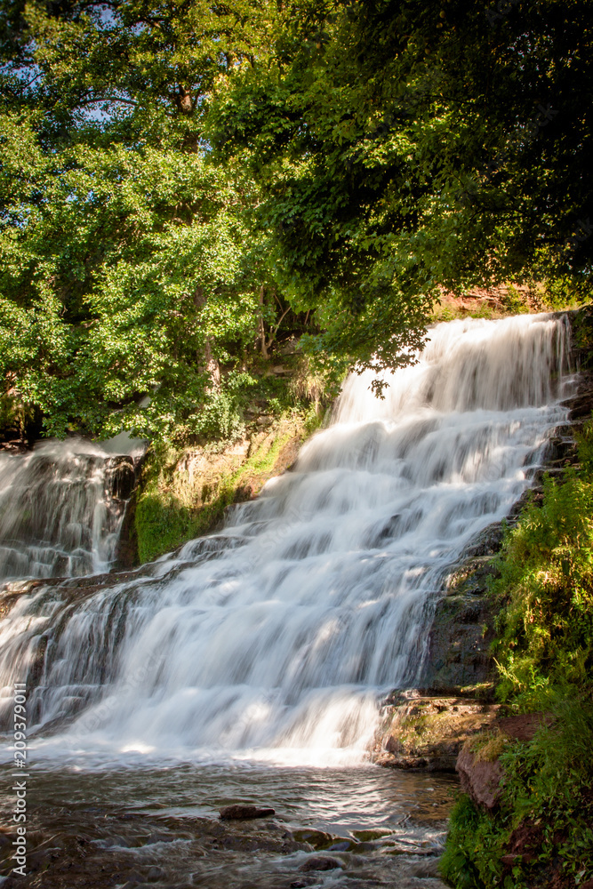 Dzhurinsky waterfall - a waterfall on the river Dzhurin in Zaleschitsky district of Ternopil region of Ukraine. The height of the waterfall is 16 meters. Dzhurinsky waterfall - a waterfall on the river Dzhurin in Zaleschitsky district of Ternopil region of Ukraine. The height of the waterfall is 16 meters.