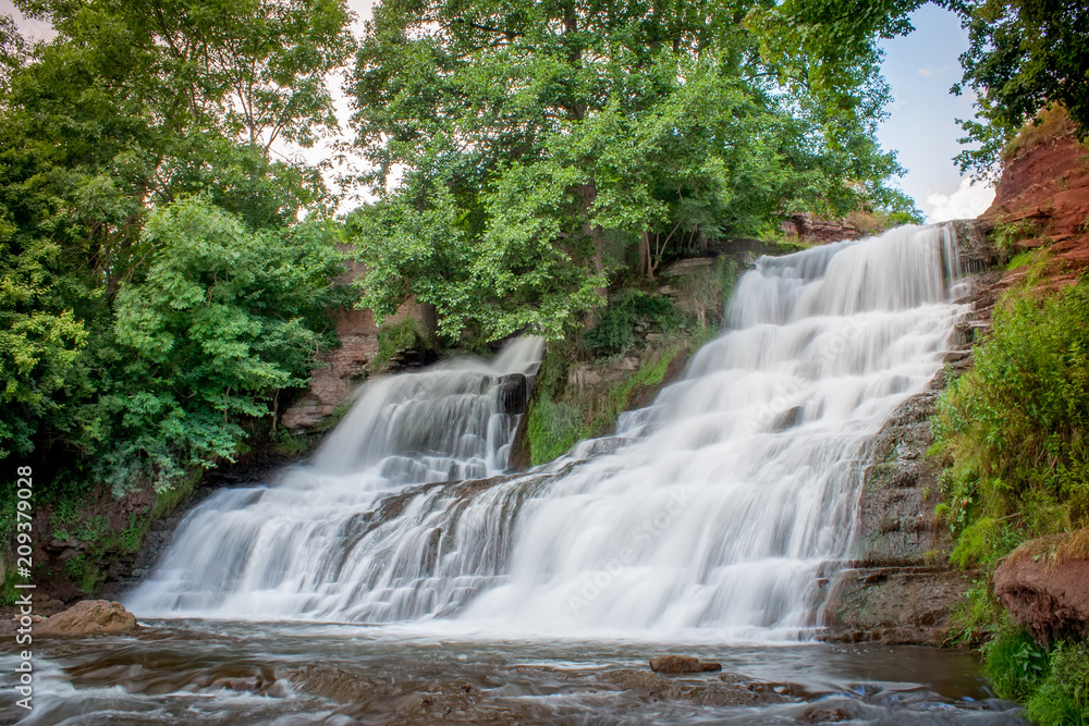 Dzhurinsky waterfall - a waterfall on the river Dzhurin in Zaleschitsky district of Ternopil region of Ukraine. The height of the waterfall is 16 meters. Dzhurinsky waterfall - a waterfall on the river Dzhurin in Zaleschitsky district of Ternopil region of Ukraine. The height of the waterfall is 16 meters.