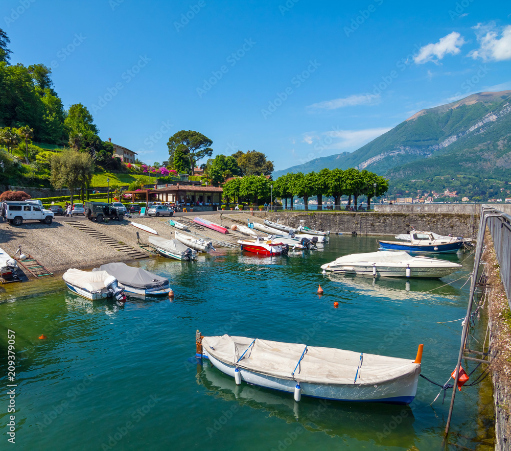 Port of Belaggio with moored boats in sunny summer day. Lombardy, Italy