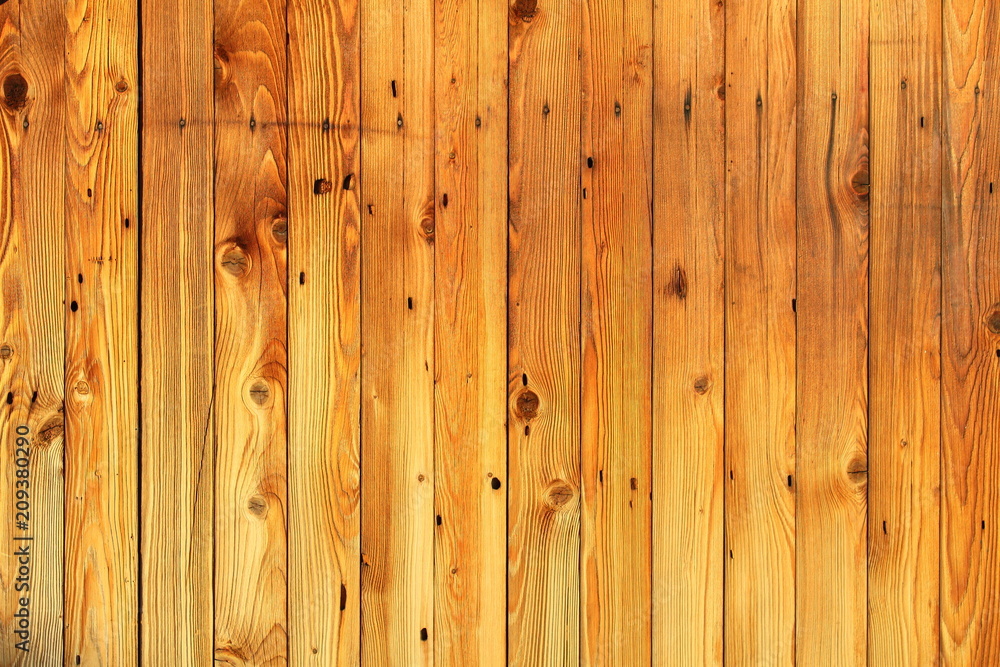 The wall of the house is made of smooth old light boards. Background.
